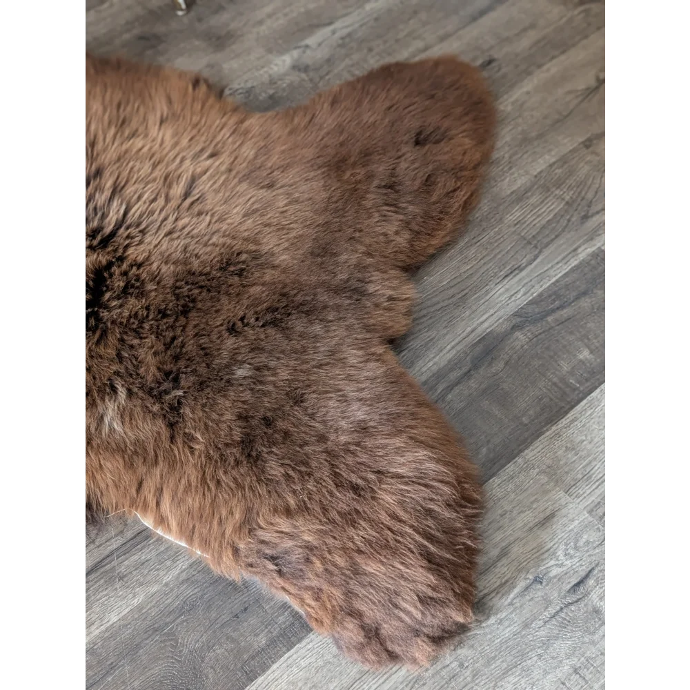 Brown plush faux fur rug with soft dense pile in an extra large british sheepskin 53 by 31 inches