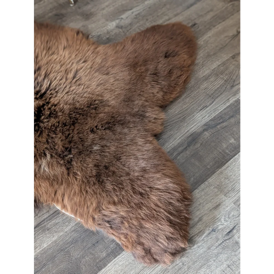 Brown plush faux fur rug with soft dense pile in an extra large british sheepskin 53 by 31 inches