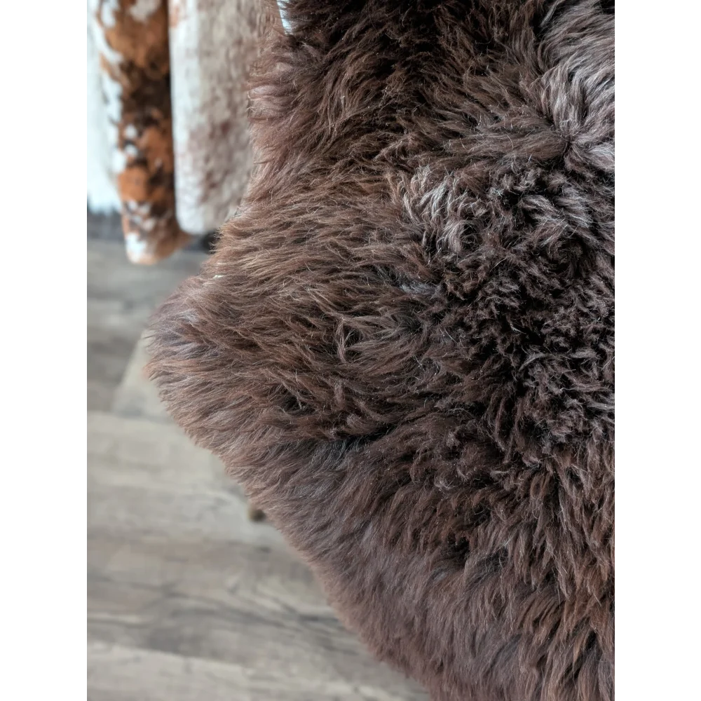 A gorgeous extra large dark brown british sheepskin rug with thick curly texture from angus oliver canada sheepskin rugs
