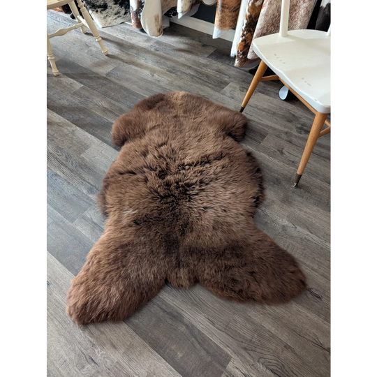 A rich brown british sheepskin rug with fluffy texture and irregular edges by angus oliver canada perfect sheepskin rugs