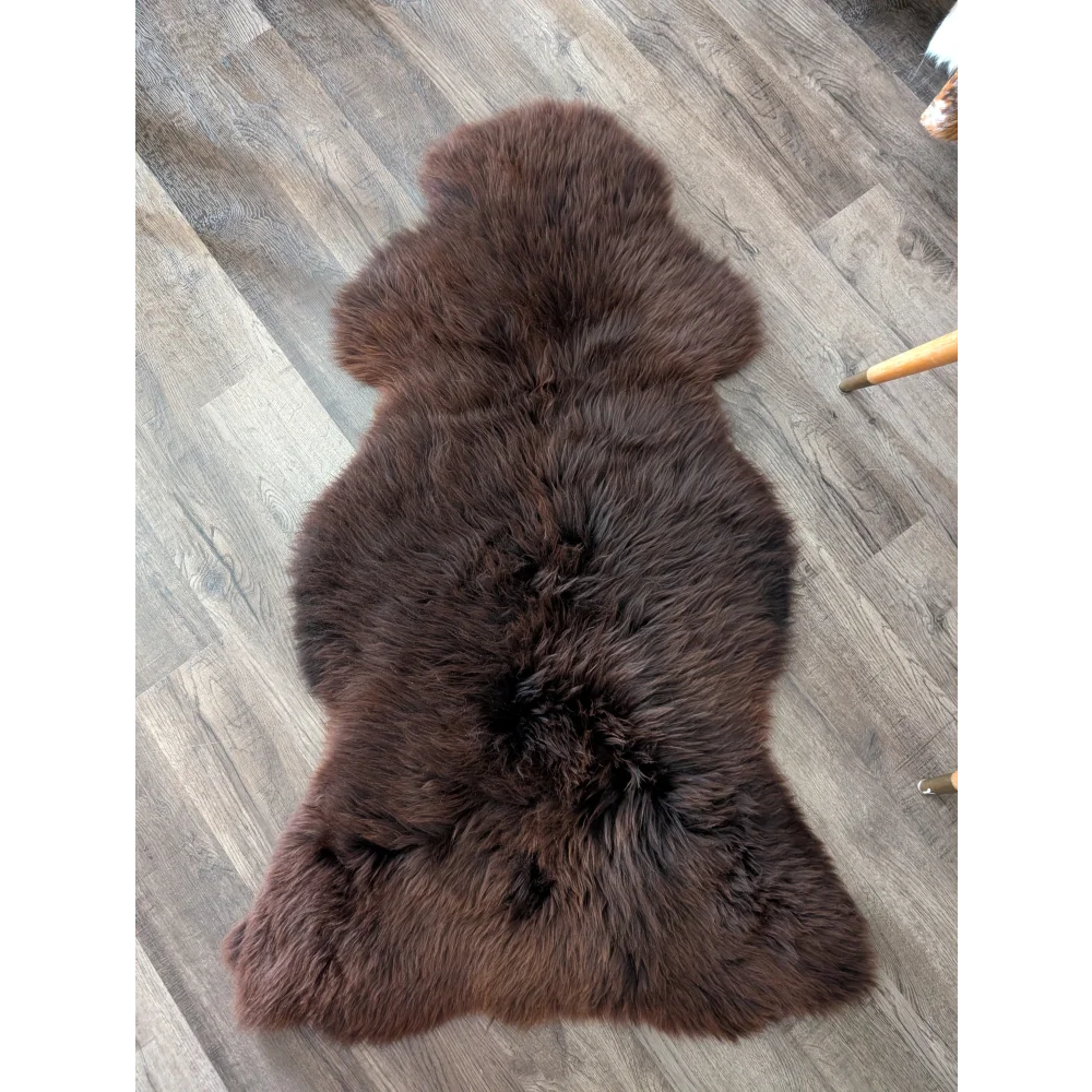 A gorgeous extra large dark brown sheepskin rug by angus oliver with soft fluffy texture perfect for cozy canada homes