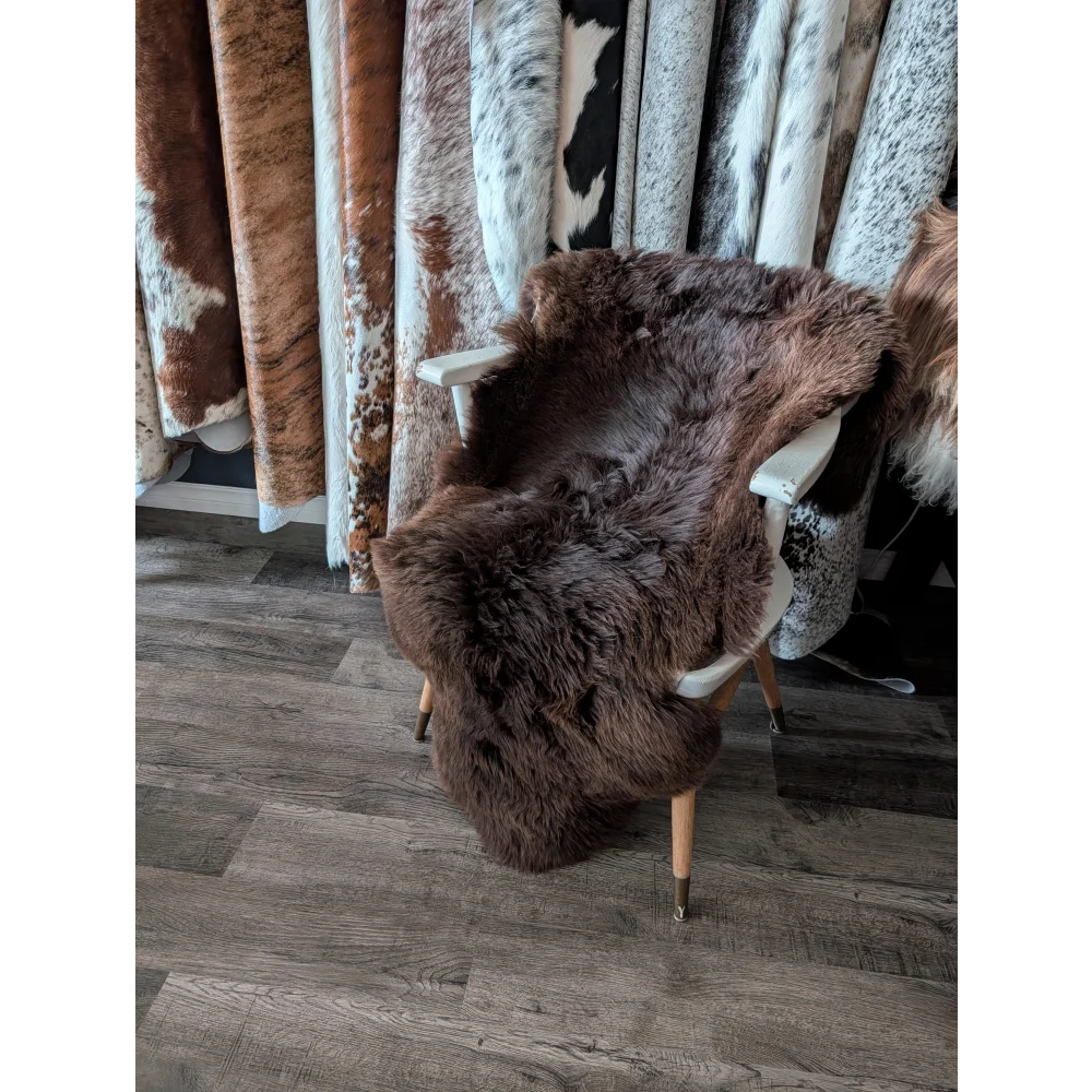 Brown angus oliver british sheepskin rug draped over white chair extra large 52 by 30 inches
