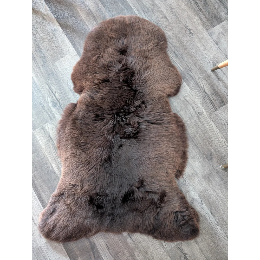 A gorgeous extra large british sheepskin rug in dark brown with soft dense fur by angus oliver perfect for cozy spaces