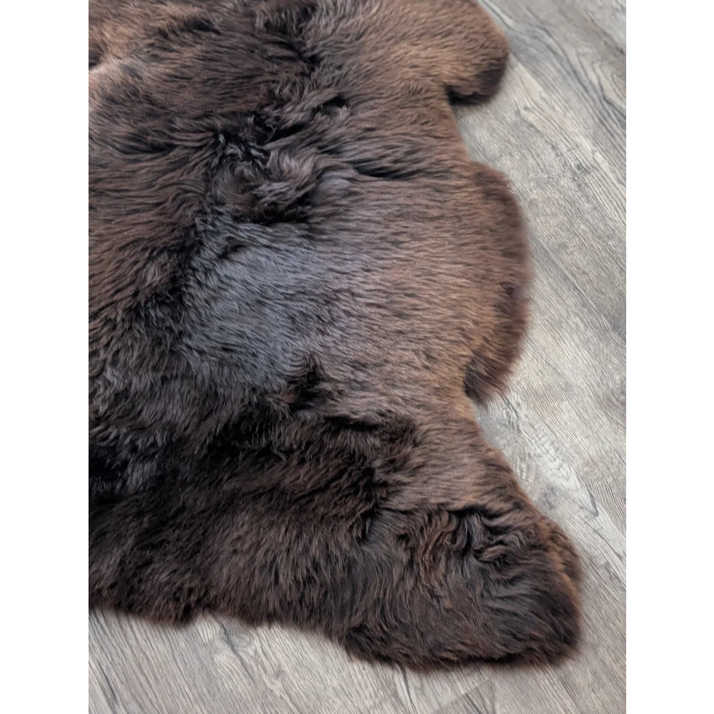 A dark brown extra large british sheepskin rug with soft dense fur from angus oliver perfect for cozy spaces