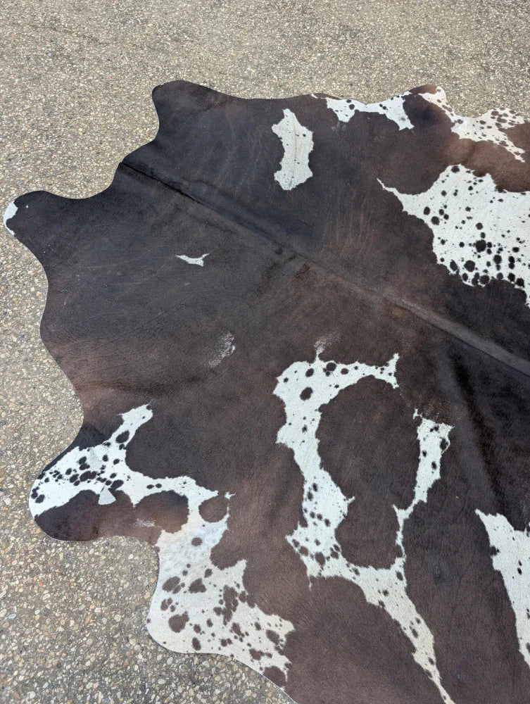 Hum12 92 x 80 extra large cowhide rug with natural brown and white spots showcasing unique characteristics in beautiful rugs