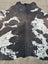 Extra large hum12 brown and white cowhide rug with natural black spots and unique characteristics for beautiful rugs