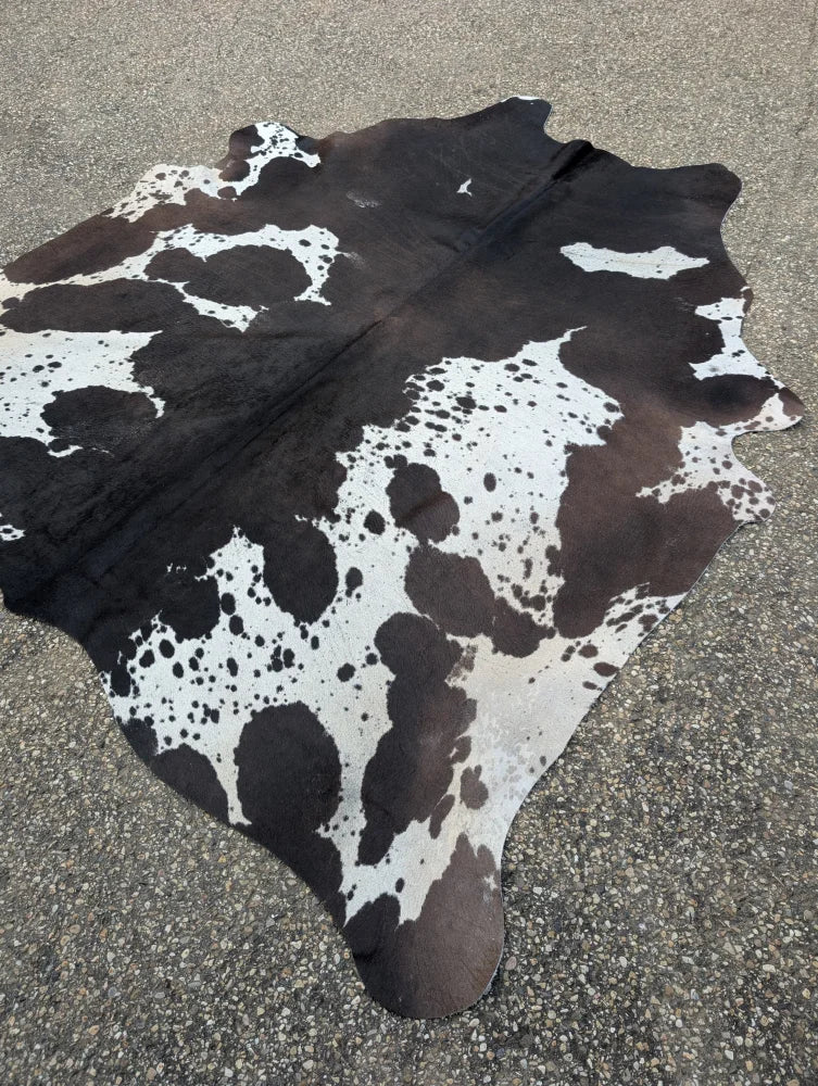 Hum12 92 x 80 extra large cowhide rug with black white brown and cream patches showcasing unique characteristics
