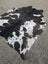 Hum12 92 x 80 extra large cowhide rug with black white brown and cream patches showcasing unique characteristics