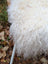 A plush off-white 48 x 32 curly long wool icelandic sheepskin throw perfect for cozy home decor