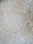 A plush off-white curly long wool icelandic sheepskin rug with soft voluminous texture perfect for cozy spaces