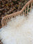 White fluffy wool icelandic sheepskin rug on woven wicker chair in ice2 49 by 30 curly long wool icelandic style