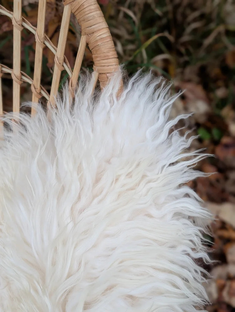 White fluffy long wool icelandic sheepskin lining inside a woven wicker basket from ice5 product line