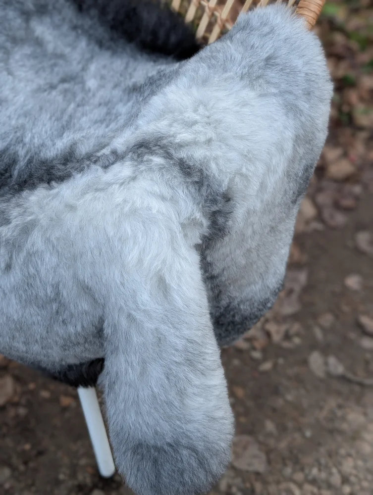 A plush gray and black faux fur stuffed animal with soft fluffy texture inspired by long wool icelandic sheepskin