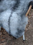 A soft fluffy gray icelandic sheepskin rug with long wool icelandic texture and natural shade variations