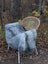 A plush natural grey icelandic sheepskin throw with long wool icelandic texture draped over a wicker chair