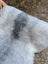 A soft fluffy natural grey massive icelandic sheepskin rug with long wool icelandic texture 53 by 25 inches