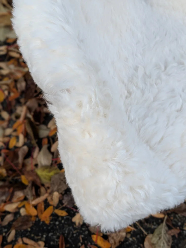 White fluffy faux fur coat made from short wool spotted icelandic sheepskin measuring 44 by 28 inches