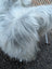 A plush long wool icelandic grey icelandic sheepskin throw draped over a chair measuring 56 by 31 inches