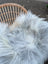 A plush long wool icelandic sheepskin throw in soft white and natural grey perfect for cozy decor