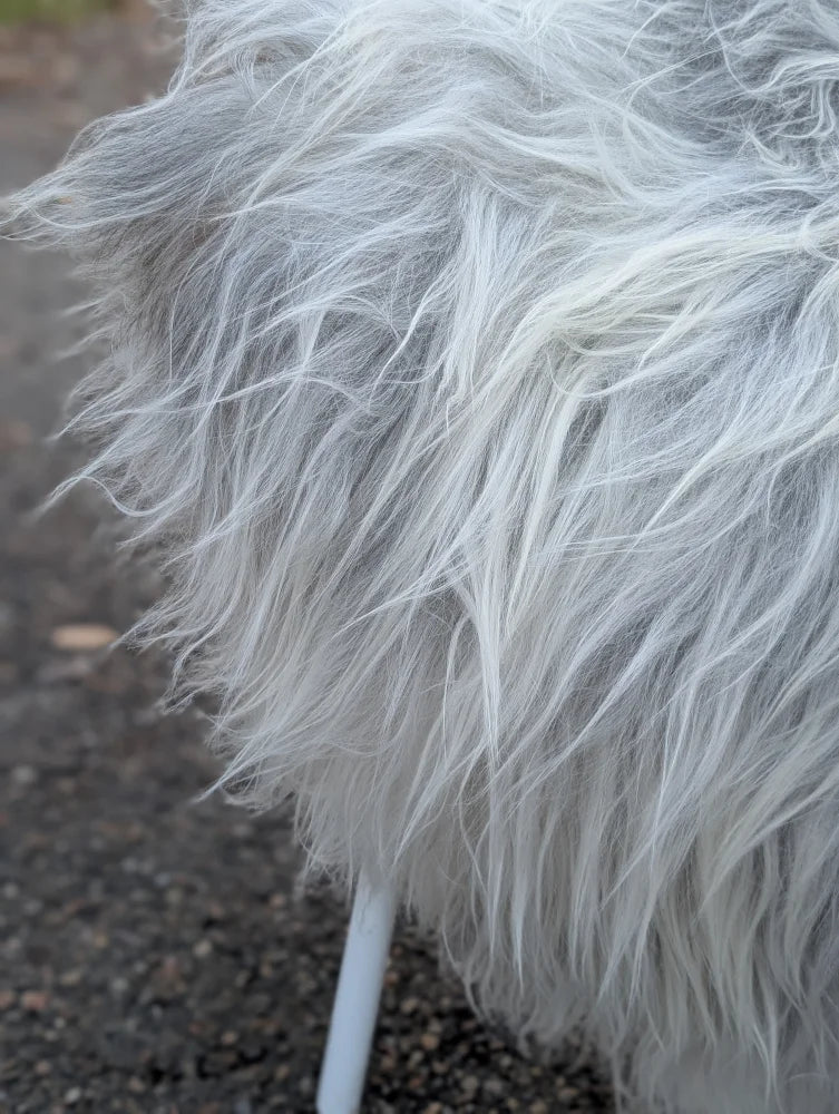 A plush long wool icelandic faux fur coat in natural grey with soft shaggy texture from massive icelandic sheepskins