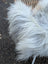A fluffy white faux fur coat with long soft strands and plush texture inspired by grey icelandic sheepskin wool
