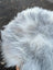 A fluffy long wool icelandic sheepskin with natural grey and white fur measuring 57 by 34 inches