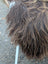 A plush shaggy brown and tan long wool icelandic sheepskin coat with a textured layered look measuring 59 by 38 inches