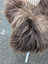 A fluffy long wool icelandic sheepskin coat in dark rusty bronze with soft shaggy texture measuring 58 by 34 inches