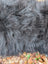 A plush dark gray long wool icelandic sheepskin blanket with thick shaggy texture for cozy warmth