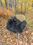 Black fluffy icelandic sheepskin throw with long wool draped over a wicker chair for cozy decor