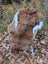 Brown fluffy icelandic sheepskin rug with white fur trim draped over wicker chair wool icelandic shortwool