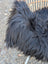 A plush black long wool icelandic sheepskin with dense shaggy texture perfect for cozy decor or wear
