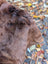 A fluffy brown dog on a soft wool icelandic sheepskin rug ice32 51 x 30.5 inches perfect for cozy decor