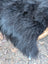 Thick natural black icelandic sheepskin coat with soft long wool and slightly wavy texture perfect for cold weather