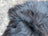 A plush dark gray long wool icelandic sheepskin texture with soft tousled natural black wool fibers