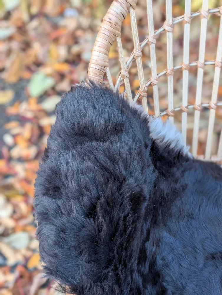 Black fluffy faux fur dog ear accessory with dark edges inspired by wool icelandic sheepskin rug style