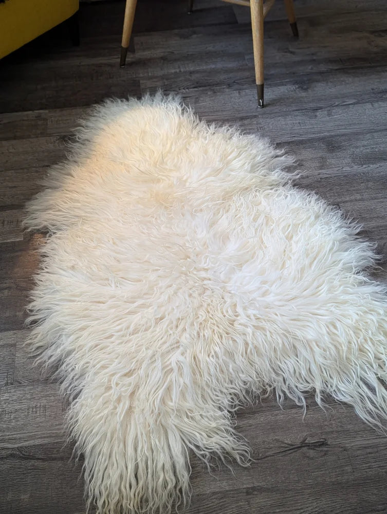 Cream-colored long wool icelandic sheepskin rug with natural curly texture and soft fluffy feel perfect for cozy decor