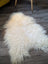 Cream-colored long wool icelandic sheepskin rug with natural curly texture and soft fluffy feel perfect for cozy decor