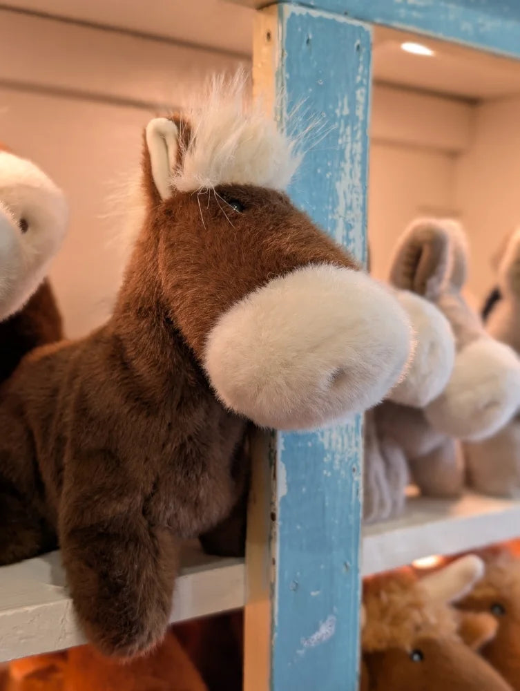 A large size plush brown horse pony with white muzzle and mane made of soft fabric named jorge the pony