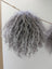 Gray curly hair wig with mushroom sheepskin pom poms