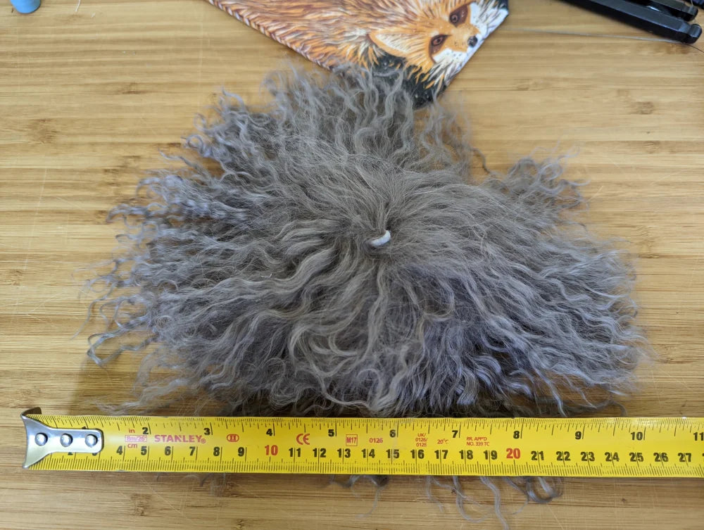Grey curly fur mushroom sheepskin pom with white string