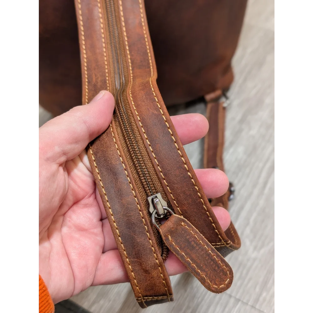Brown leather shoulder bag strap with tan stitching on Leather Backpack GW006B