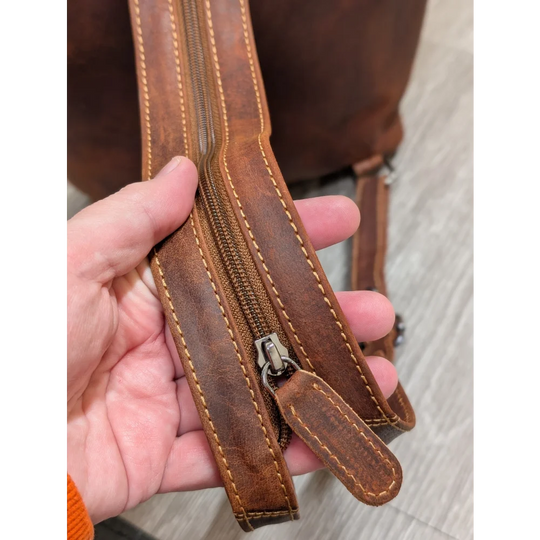 Brown leather shoulder bag strap with tan stitching on Leather Backpack GW006B