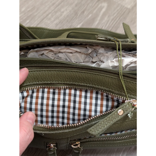Olive green leather crossbody bag with checkered interior lining