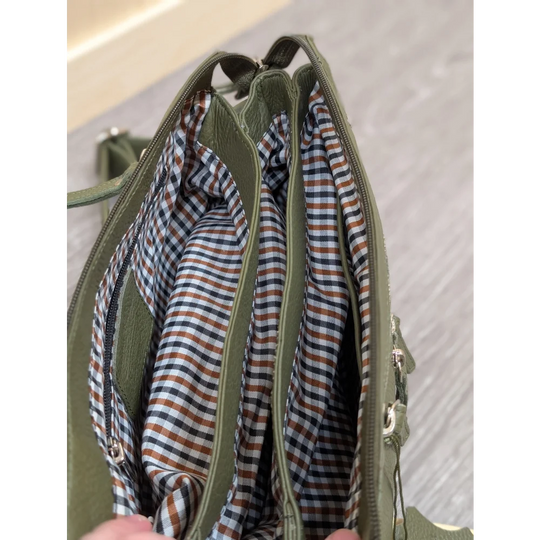 Olive green leather crossbody bag with plaid interior lining