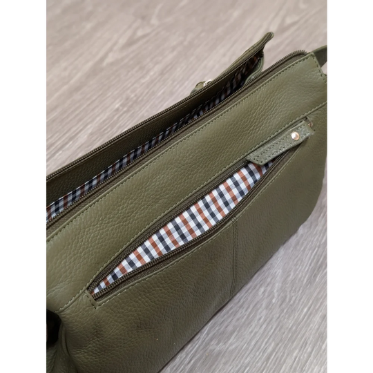 Olive green leather crossbody bag with striped interior lining