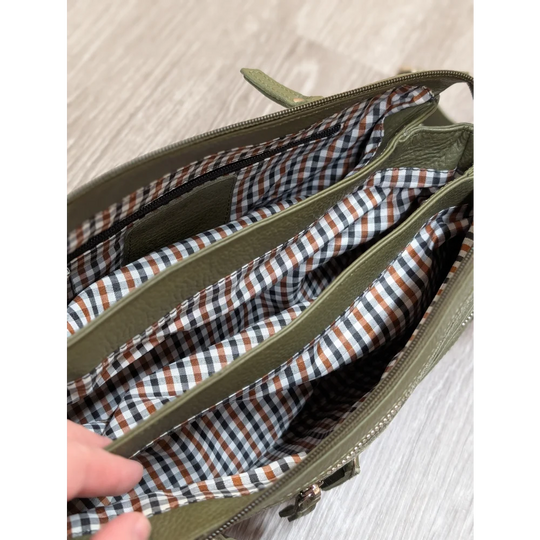 Olive green leather crossbody bag with checkered interior lining