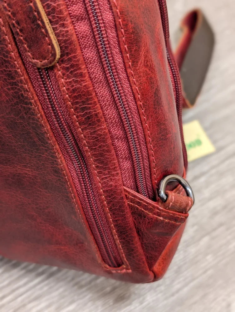 Red Ajax sling bag in textured wax pull-up leather with stitching