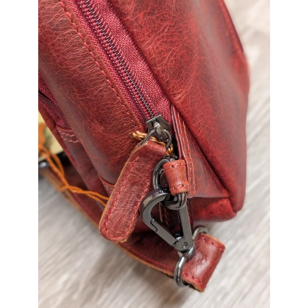 Red wax pull-up leather Ajax sling bag with zipper and carabiner