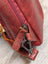Red wax pull-up leather Ajax sling bag with zipper and carabiner